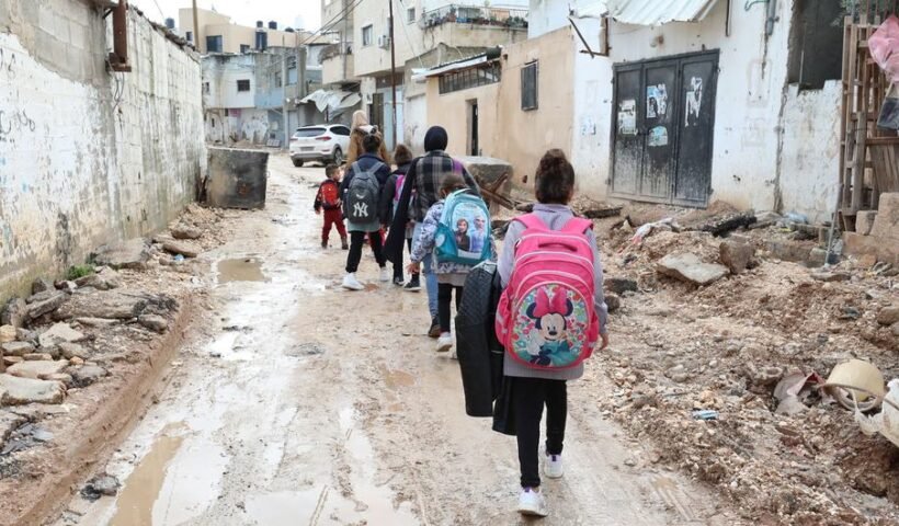 Children walk through partially destroyed streets in Jenin in the West Bank.